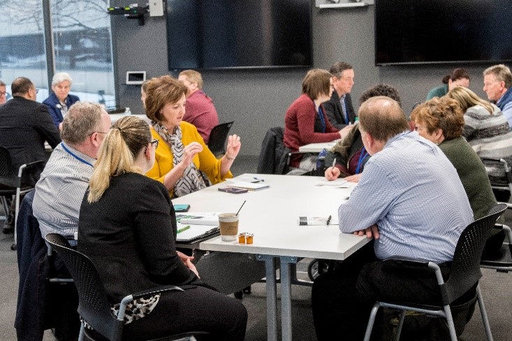 Photo of people discussing topics at the Tools to Mitigate Stress & Promote Workplace Mental Health event held January 15, 2019.