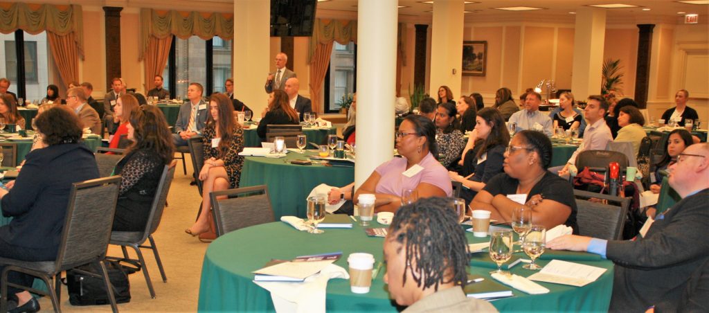 Attendees listen to the panel discussion